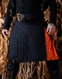 A front view of the Spooky Spider Kilt, showcasing its intricate black and gray spider web embroidery across the fabric. The bold, modern design is striking against the dark background, paired with silver accents and sturdy belt loops for an edgy yet structured look.